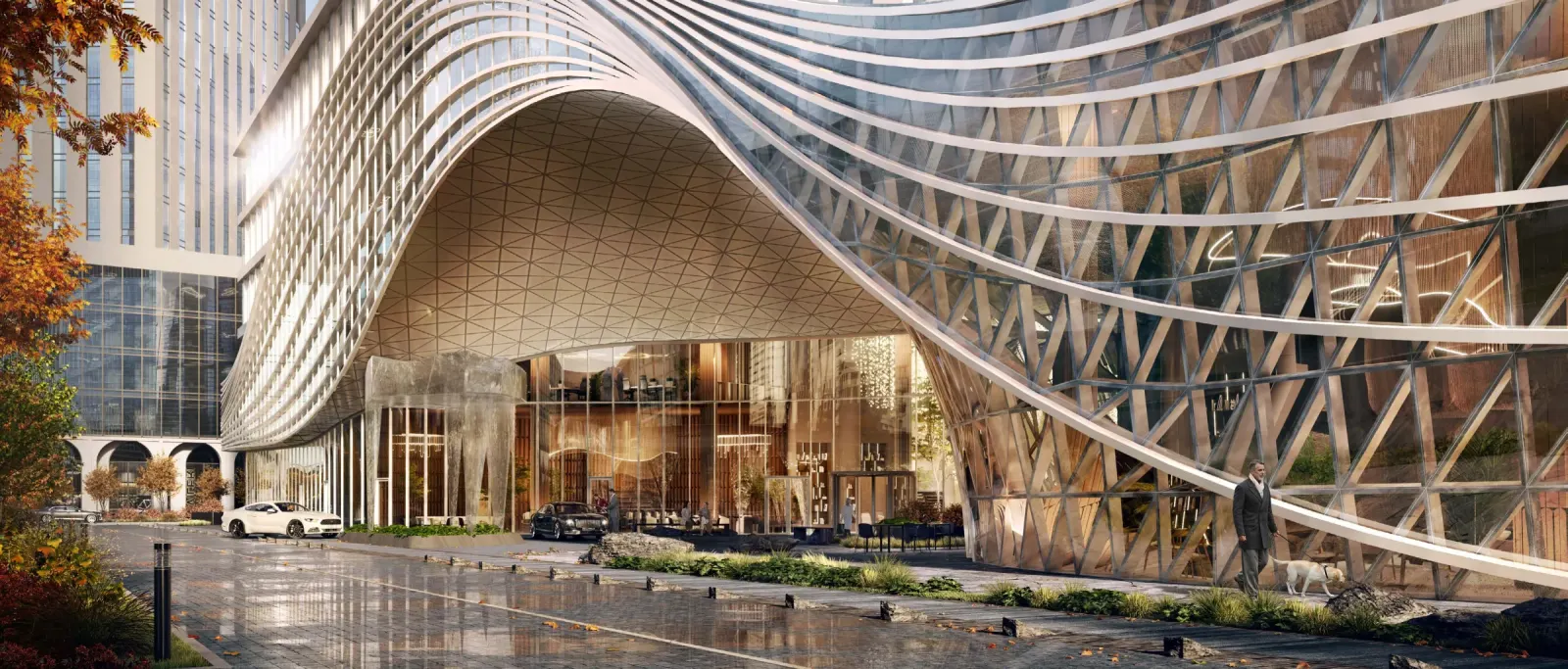 Вход в AURUS Residences — волнообразный фасад над парадным лобби, автомобиль у входа