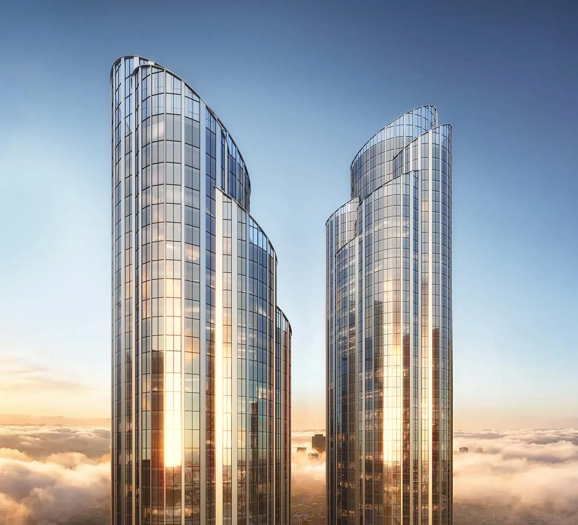 Две башни AURUS Residences в золотой час, вид с высоты облаков